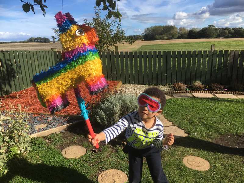 Lewis Adaramoye gets stuck in to the piñata.